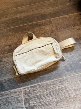 Compact Cream Crossbody Bag with Subtle Logo Detail